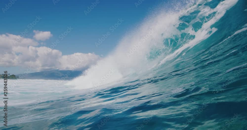 Breaking wave with tropical island paradise in background Breaking wave with tropical island paradise in background
