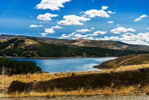 Fototapeta Naklejka Na Ścianę i Meble -  Beautiful landscape photo of turquoise aquamarine lake water and colorful yellow steppes in the mountains of Patagonia, Argentina