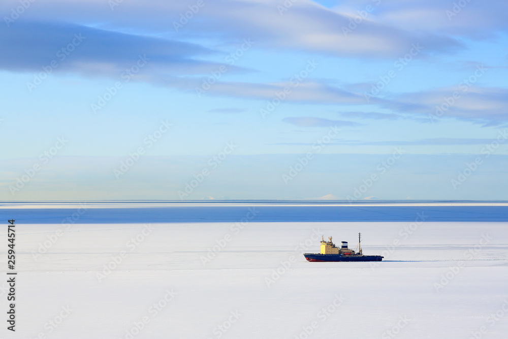 Icebreaker among the ice. Maritime navigation in the north. Cold winter weather. Lonely ship and sea spaces. Nagaev Bay, Sea of Okhotsk, Magadan, Far East of Russia. Icebreaker among the ice. Maritime navigation in the north. Cold winter weather. Lonely ship and sea spaces. Nagaev Bay, Sea of Okhotsk, Magadan, Far East of Russia.