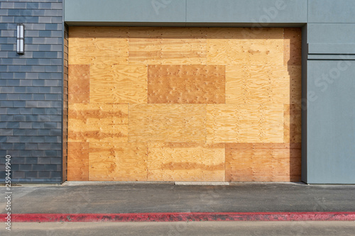 Preparation for hurricane - store, restaurant boarded up with plywood sheets. Plywood shutters prevent unauthorized access by squatters, looters or vandals to unused, vacant, or abandoned property photo