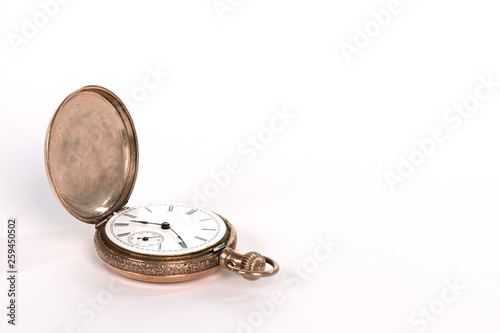 Antique gold pocket watch isolated on white with copy space