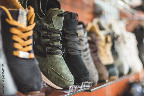 Men's sneakers on the store shelf. Sports shoes in the shop pavilion.