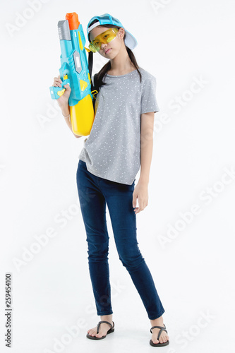 Happy beauty Asian girl holding plastic water gun at Songkran festival, Thailand. Isolated on white background
