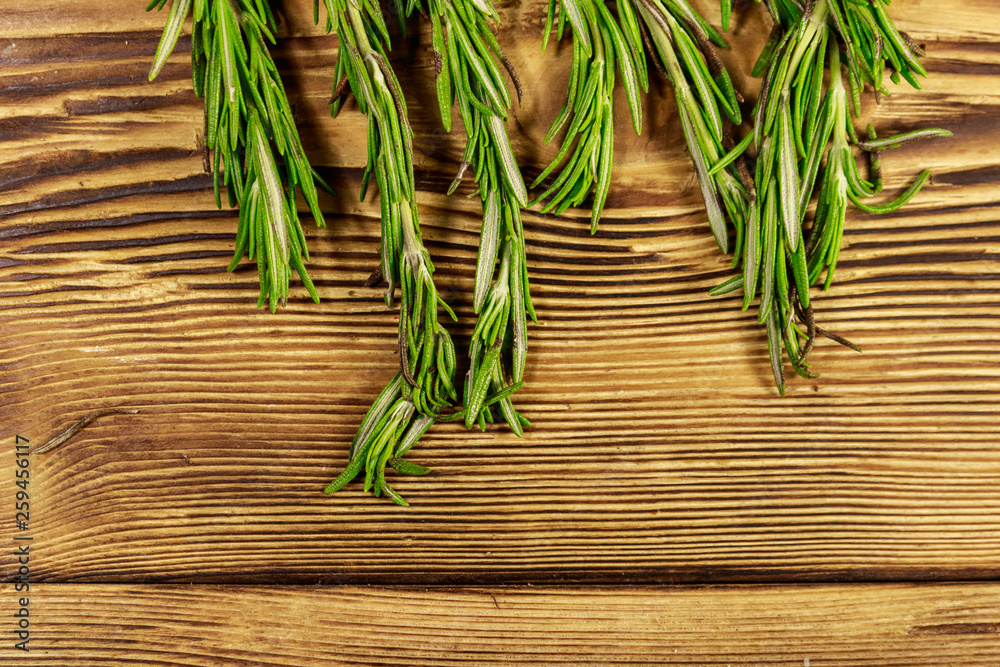 Fresh rosemary herbs on a wooden table. Top view Fresh rosemary herbs on a wooden table. Top view