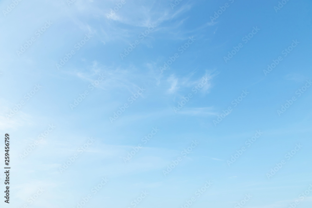 Beautiful clear blue sky background with tiny plain white cloud on morning time rays sunlight. space for text. soft focus.