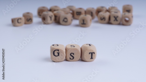 Wallpaper Mural GST inscription on wooden alphabet over white background with selective focus Torontodigital.ca