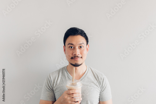 Happy man is drinking Bubble Milk Tea or Pearl Milk Tea. Popular Milk Tea in Asia and Taiwan.