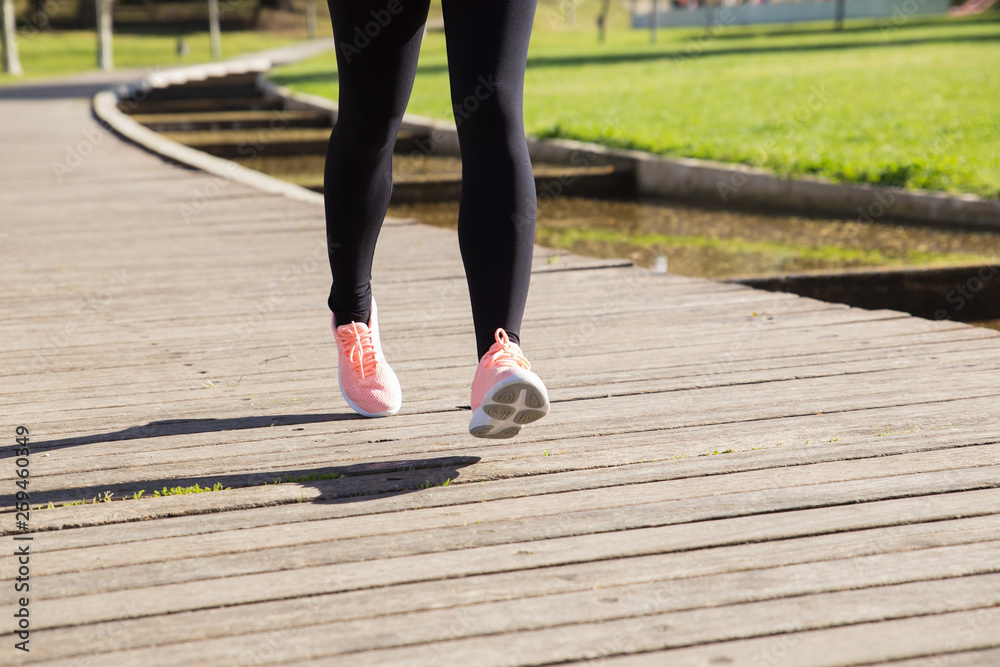 Closeup of woman jogging in city park Closeup of woman jogging in city park