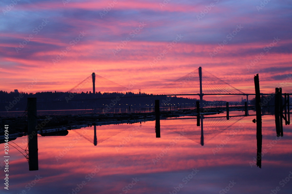 Sunset over the Port Mann Bridge with Fraser River running under Port Coquitlam British Columbia 