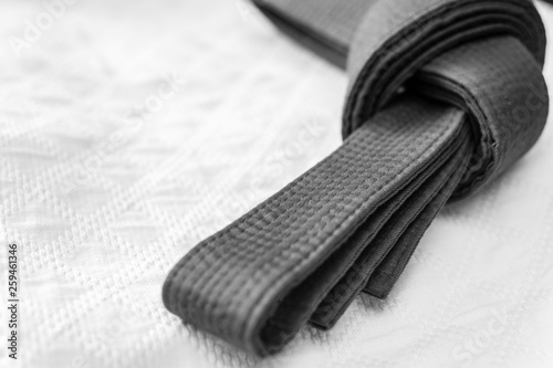 Black judo, aikido or karate belt on white kimono