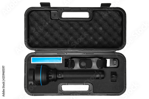 modern black flashlight in plastic case isolated on white back