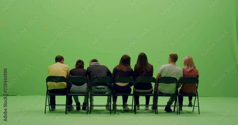 GREEN SCREEN CHROMA KEY Back view group of young people watching and cheering at a sport event. 4K UHD ProRes 4444