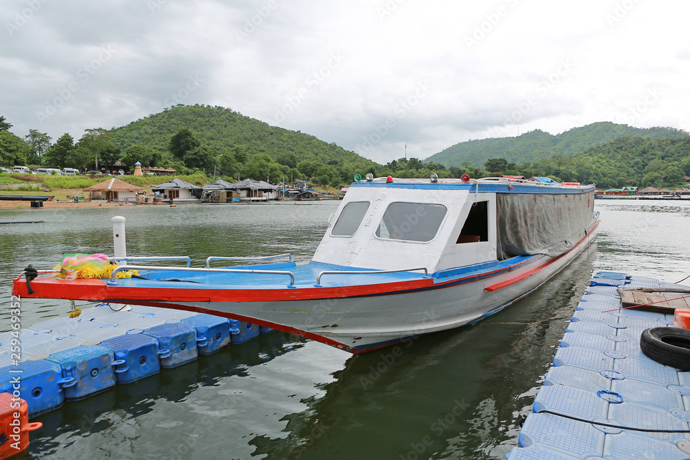 Thai boat floating on river and bungalows floating on river at kanchanaburi, Thailand. Thai boat floating on river and bungalows floating on river at kanchanaburi, Thailand.