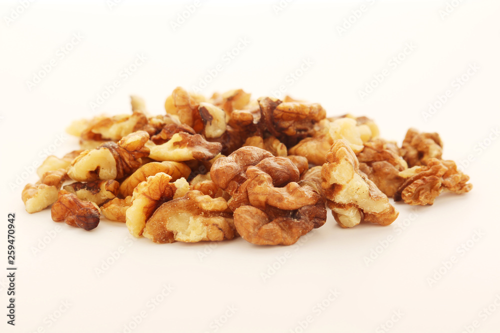 A pile of peeled walnuts at white background A pile of peeled walnuts at white background