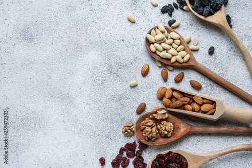 Fototapeta Naklejka Na Ścianę i Meble -  Assortment of tasty dried fruits and nuts on grey background
