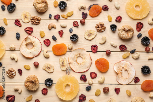 Assortment of tasty dried fruits and nuts on wooden table