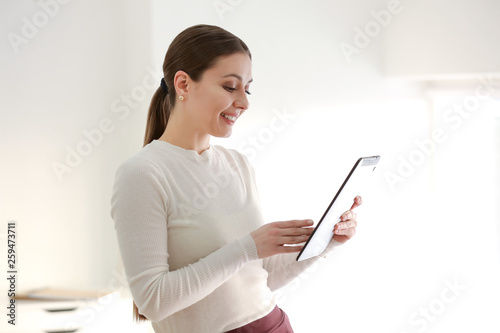 Businesswoman with tablet computer in office