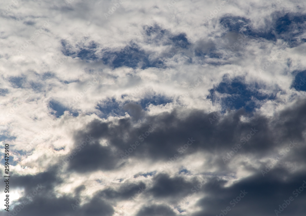 Clouds against the blue sky as a background