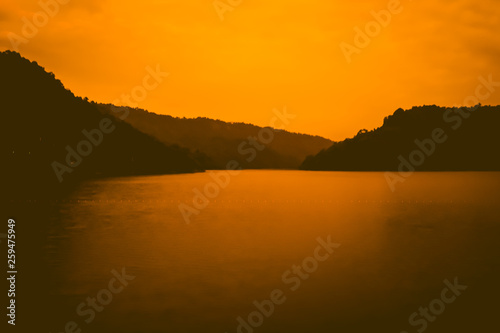 Orange sky over silhouette mountain twilight sky