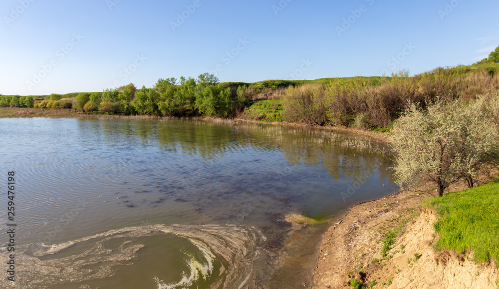 Fototapeta premium Pond in spring steppe as background