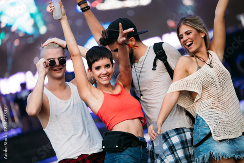 Group of friends having great time on music festival