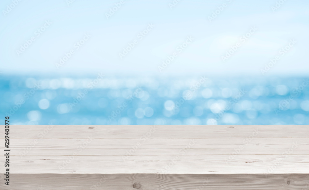 Fototapeta premium Blurred sea background with wood resort deck floor foreground