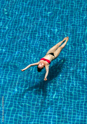 Summer vacation, woman relaxing in pool