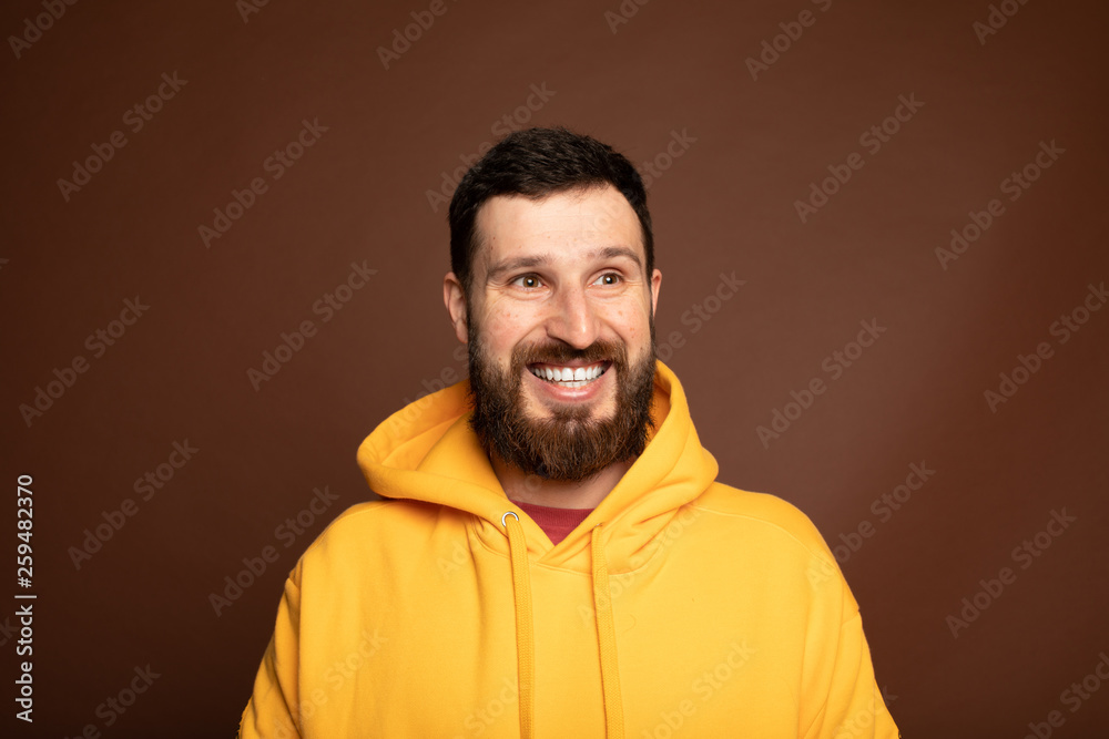 Horizontal close up portrait of a man with beard laughing on isolated color background 