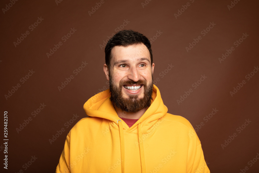 Horizontal close up portrait of a man with beard laughing on isolated color background Horizontal close up portrait of a man with beard laughing on isolated color background