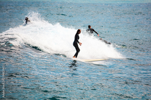 Summer time on beach and surfer on board. Sea and beach and vacation and active lifestyle concept.