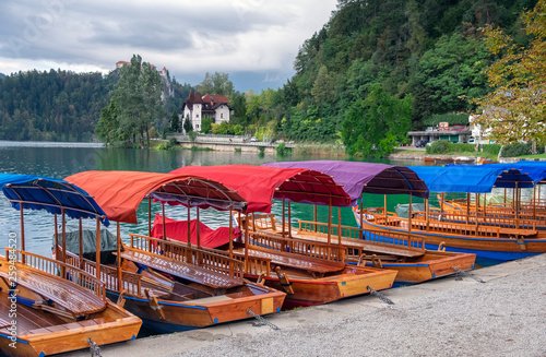 Traditional wooden flat-bottom vibrant boats "Pletna" at Lake Bled. Slovenia