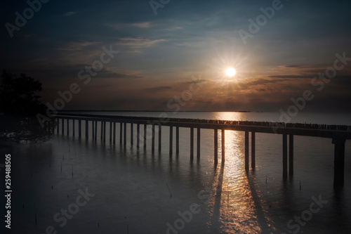 Cement bridge the pier extending into the sea © Thongtawat