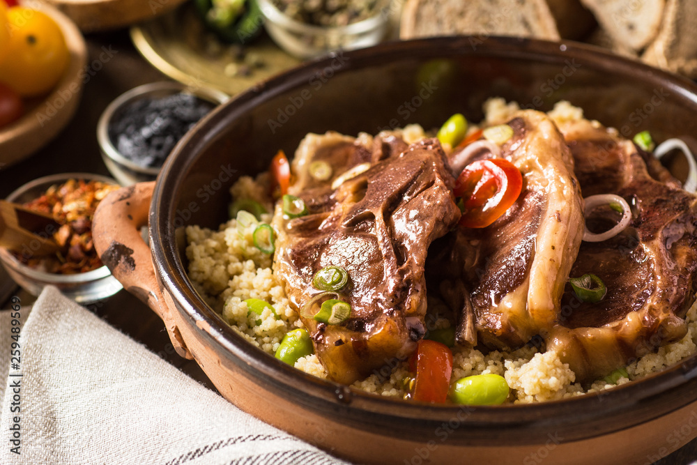 Homemade Roasted Lamb Loin Chops with Couscous and Soybean in Rustic Clay Dish