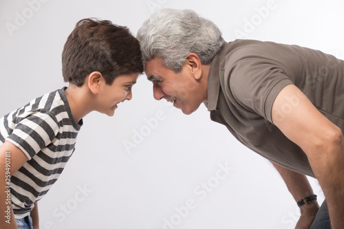 Side view of grandfather and grandson looking at each other 