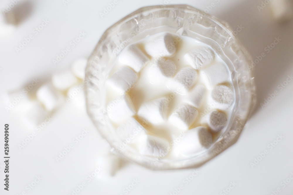 marshmallow in a glass of milk. marshmallows on a white background