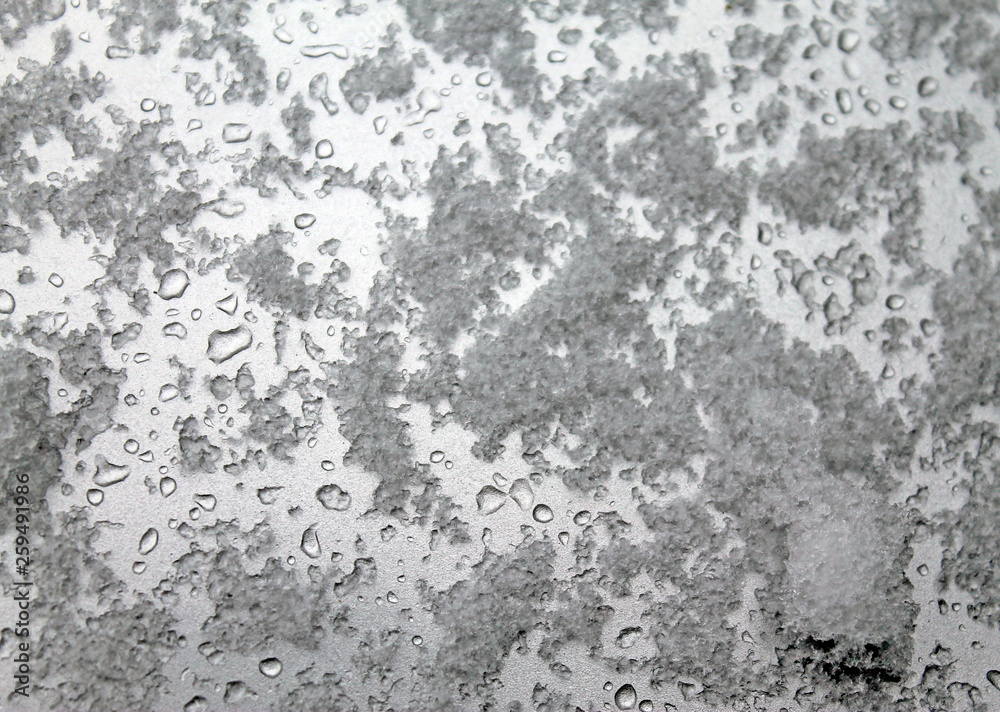 Obraz premium melting snow on the glass. sleet on glass