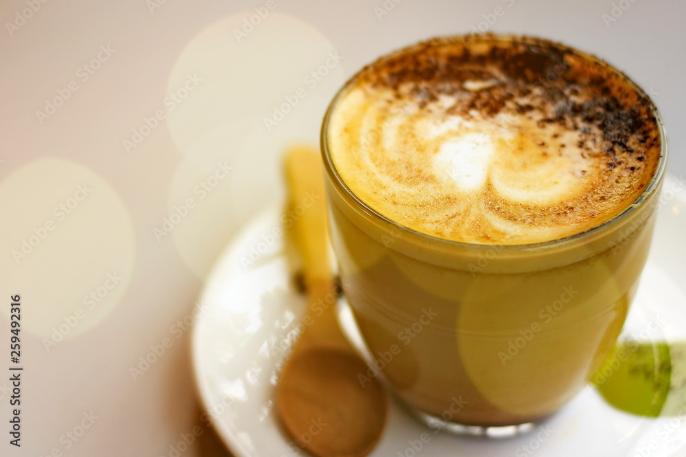 Hot latte coffee on the table with blurred bokeh background. Hot latte coffee on the table with blurred bokeh background.
