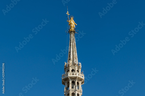 Golden statue of Virgin Mary, placed at the rooftop of Duomo cathedral in Milan, Italy © Andrej