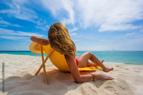 Woman enjoying her holidays on a transat at the tropical beach