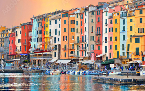 Picturesque sunset panorama with landscape of the harbor with colorful houses and the boats in Porto Venere, Italy, Liguria