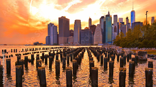 warm sunset on manhattan modern architecture skyline with moody reflections on Hudson river  Manhattan New York city