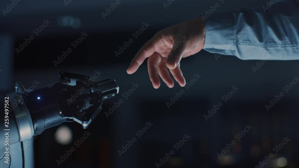 Futuristic Robot Arm Touches Human Hand in Humanity and Artificial Intelligence Unifying Gesture. Conscious Technology Meets Humanity. Concept Inspired by Michelangelo's Creation of Adam