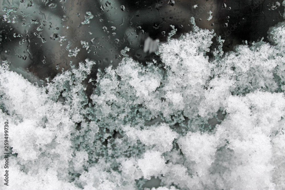 melting snow on the glass. sleet on glass melting snow on the glass. sleet on glass