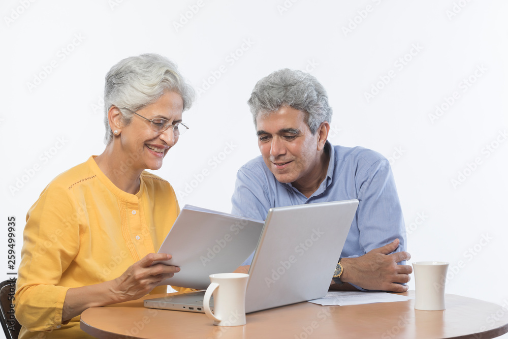 Senior couple using laptop	