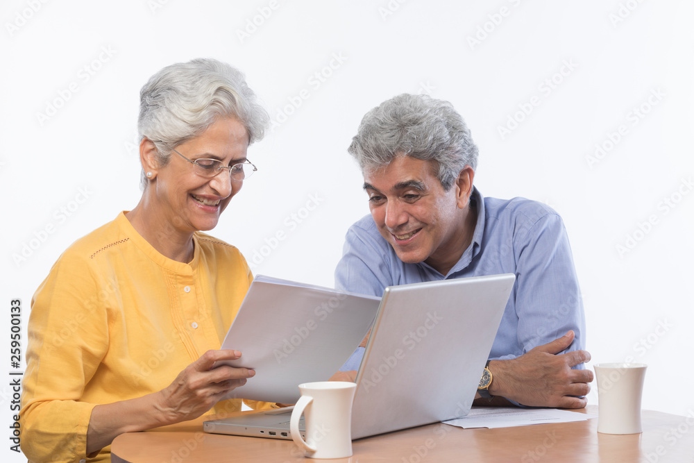Senior couple using laptop	