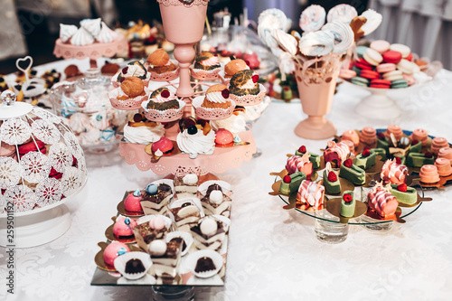 delicious cupcake. candy bar at luxury wedding reception. exclusive expensive catering. table with modern desserts, cupcakes, sweets with fruits. space for text. baby or bridal shower.