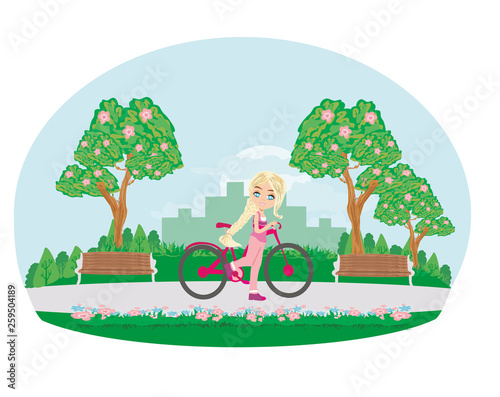 sweet girl on a bike in the park