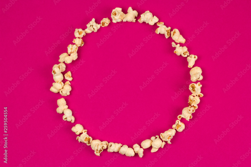 top view food fashion flat lay popcorn circle frame with copy space on a pink background