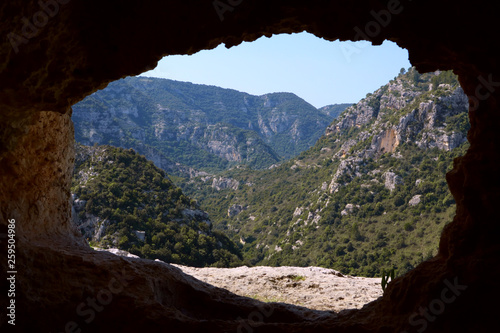 Large valley in the mountains seen from a cave