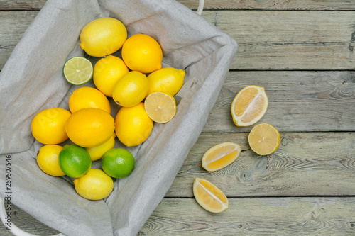 lemons and limes on a wooden background.